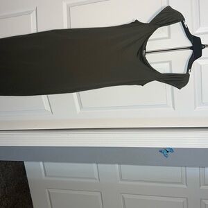Long green dress with bottom slit in the back.